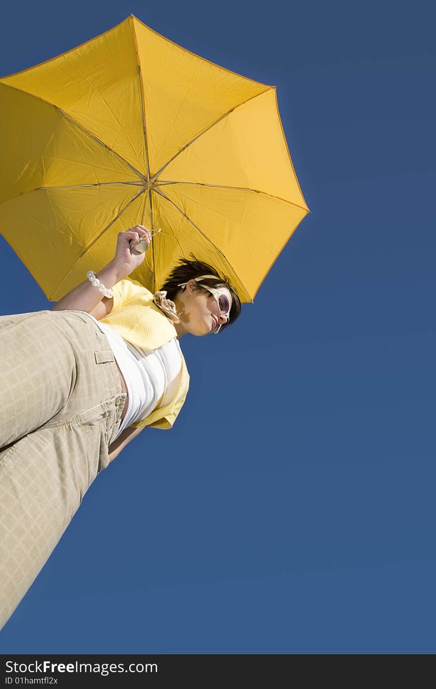 Glamour woman under yellow umbrella