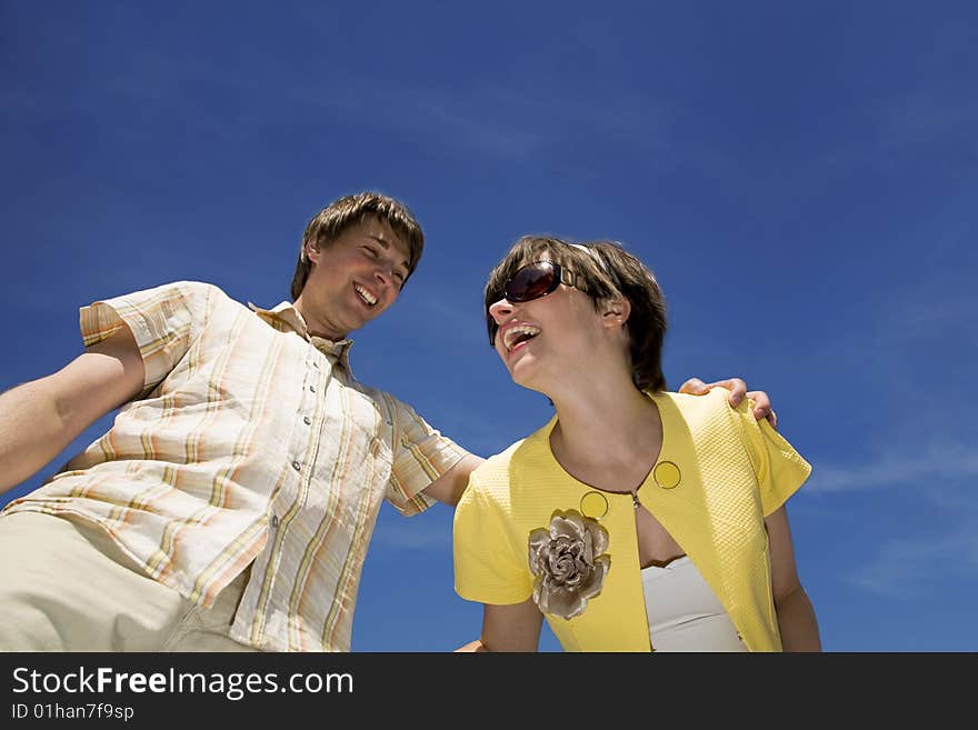 Happy couple smile over blue background