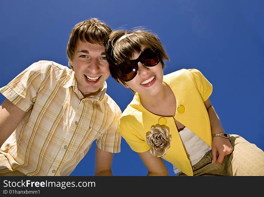 Happy couple smile over blue background