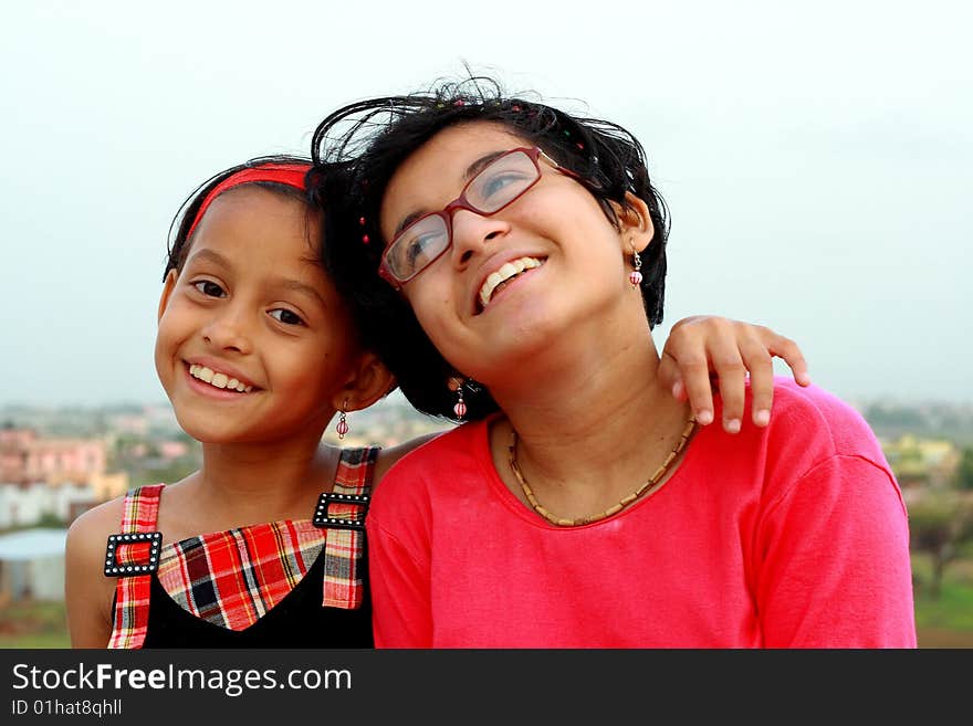 Two Indian girls smiling happily in a jolly good mood. Two Indian girls smiling happily in a jolly good mood.