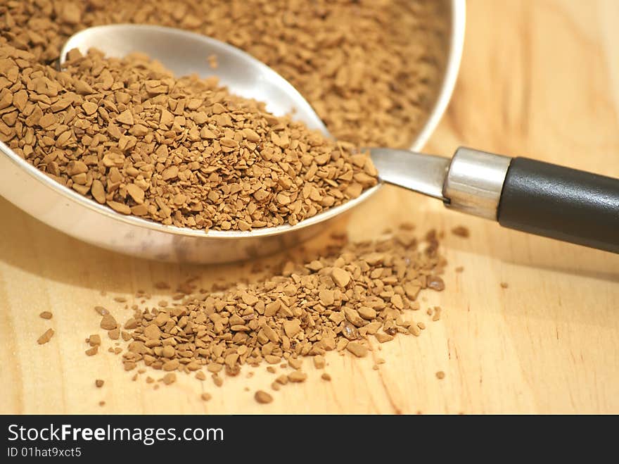 A macro view of coffee granules and a spoon. A macro view of coffee granules and a spoon