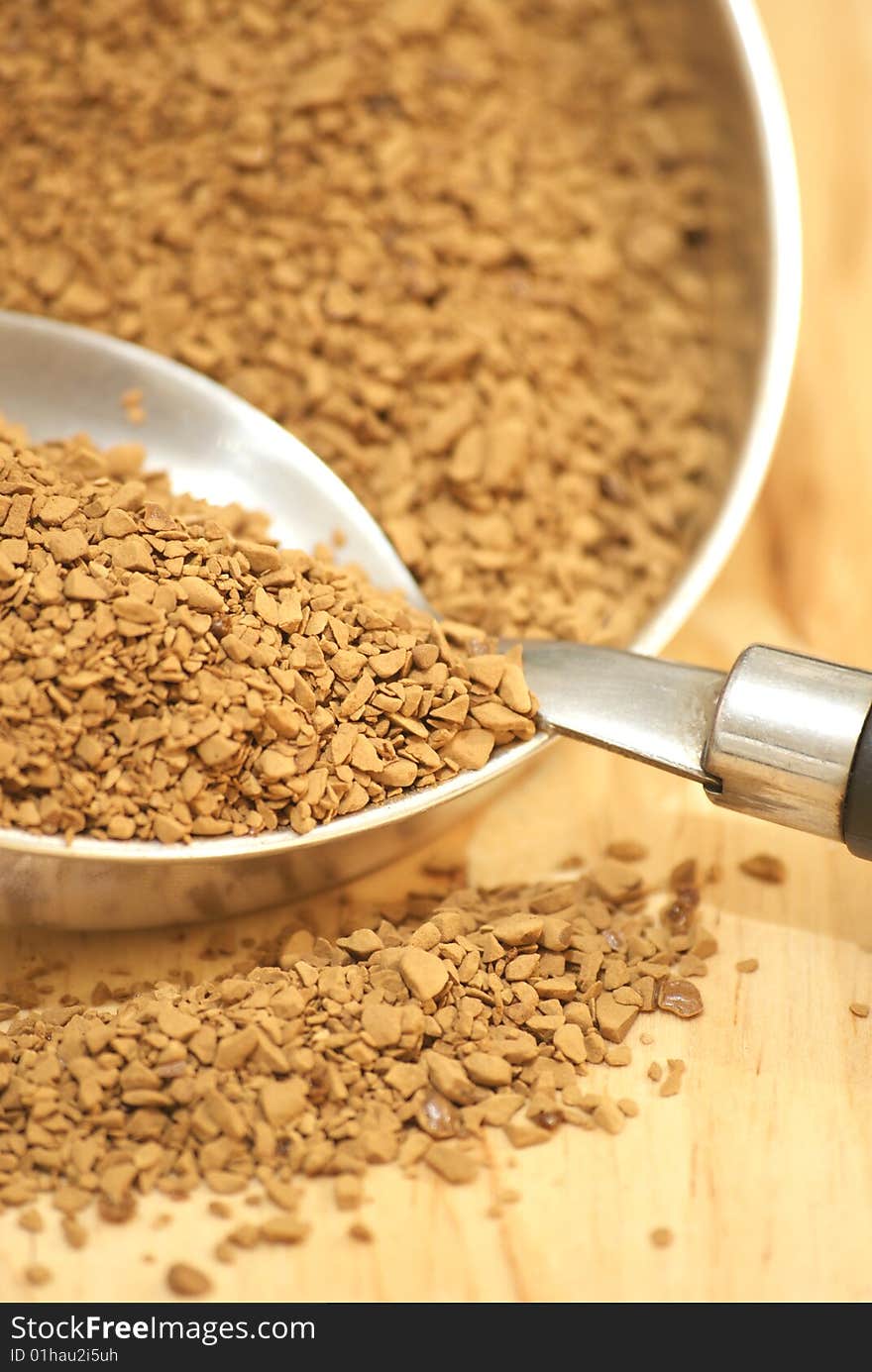 A macro view of coffee granules and a spoon. A macro view of coffee granules and a spoon