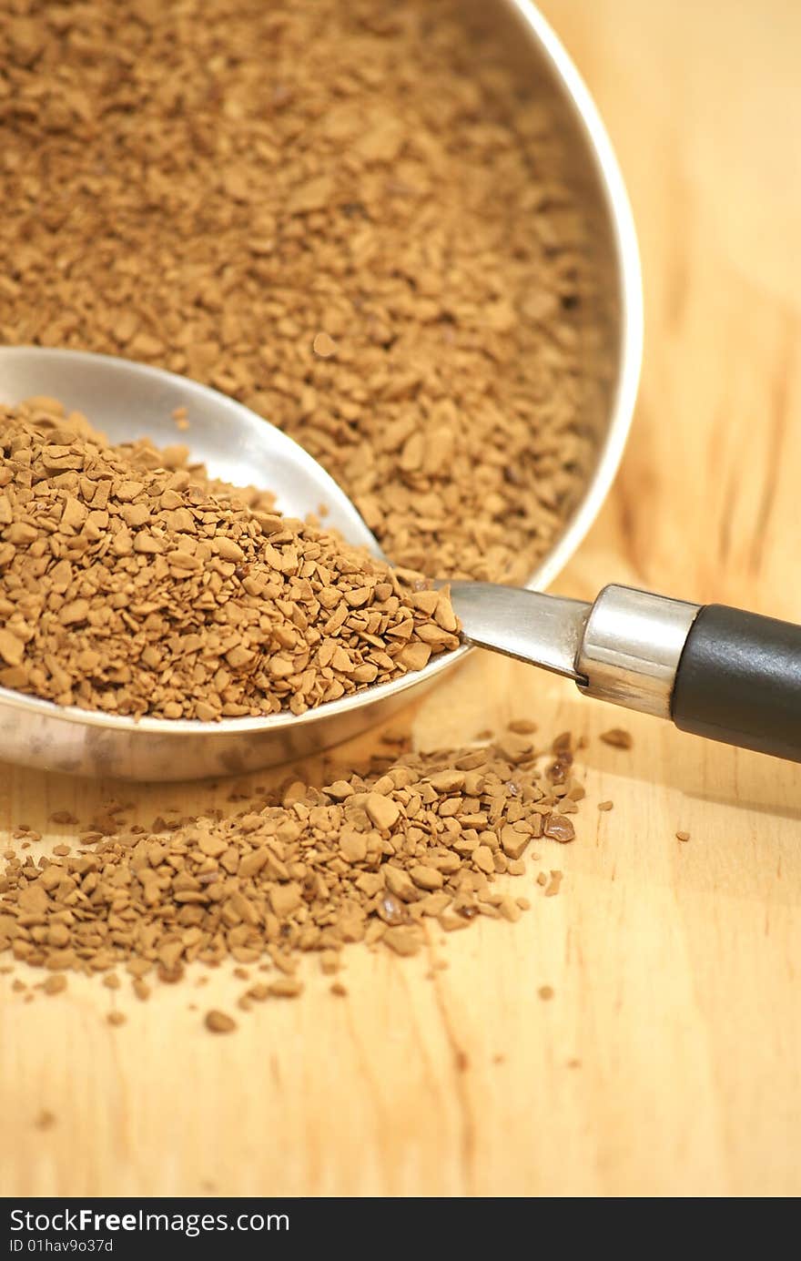 A macro view of coffee granules and a spoon. A macro view of coffee granules and a spoon