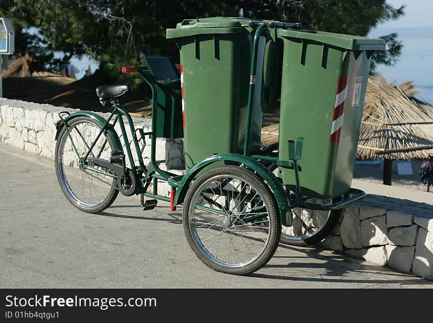 Two green plastic containers for garbage on wheels. Two green plastic containers for garbage on wheels