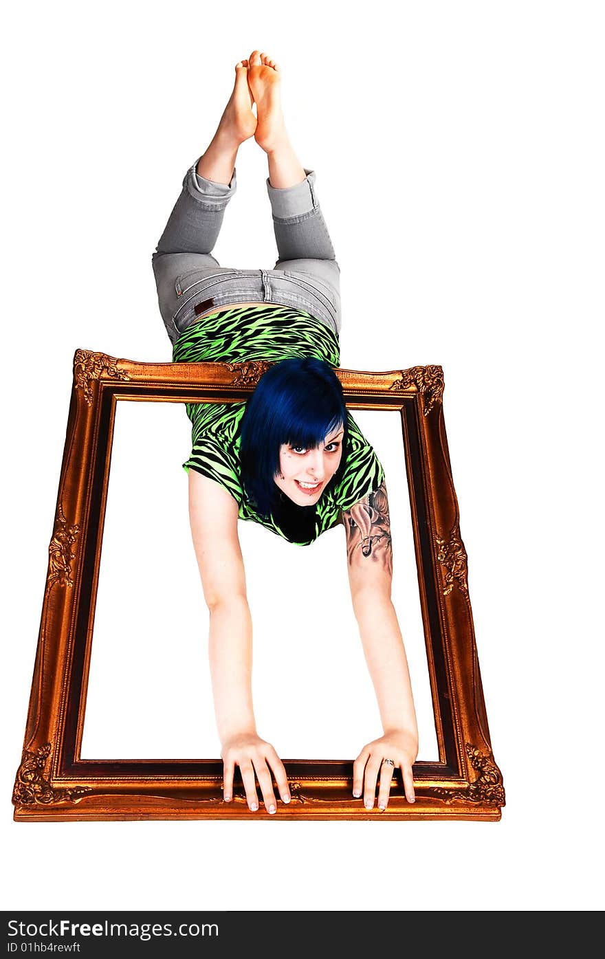 An young girl with blue hair laying on the stomach on the floor holding a picture frame over her body on white background. An young girl with blue hair laying on the stomach on the floor holding a picture frame over her body on white background.