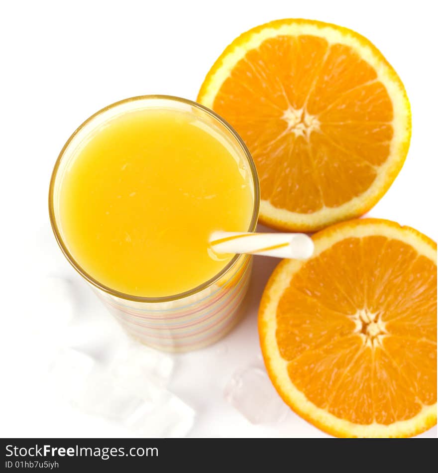 Oranges, ice and juice in glass on white