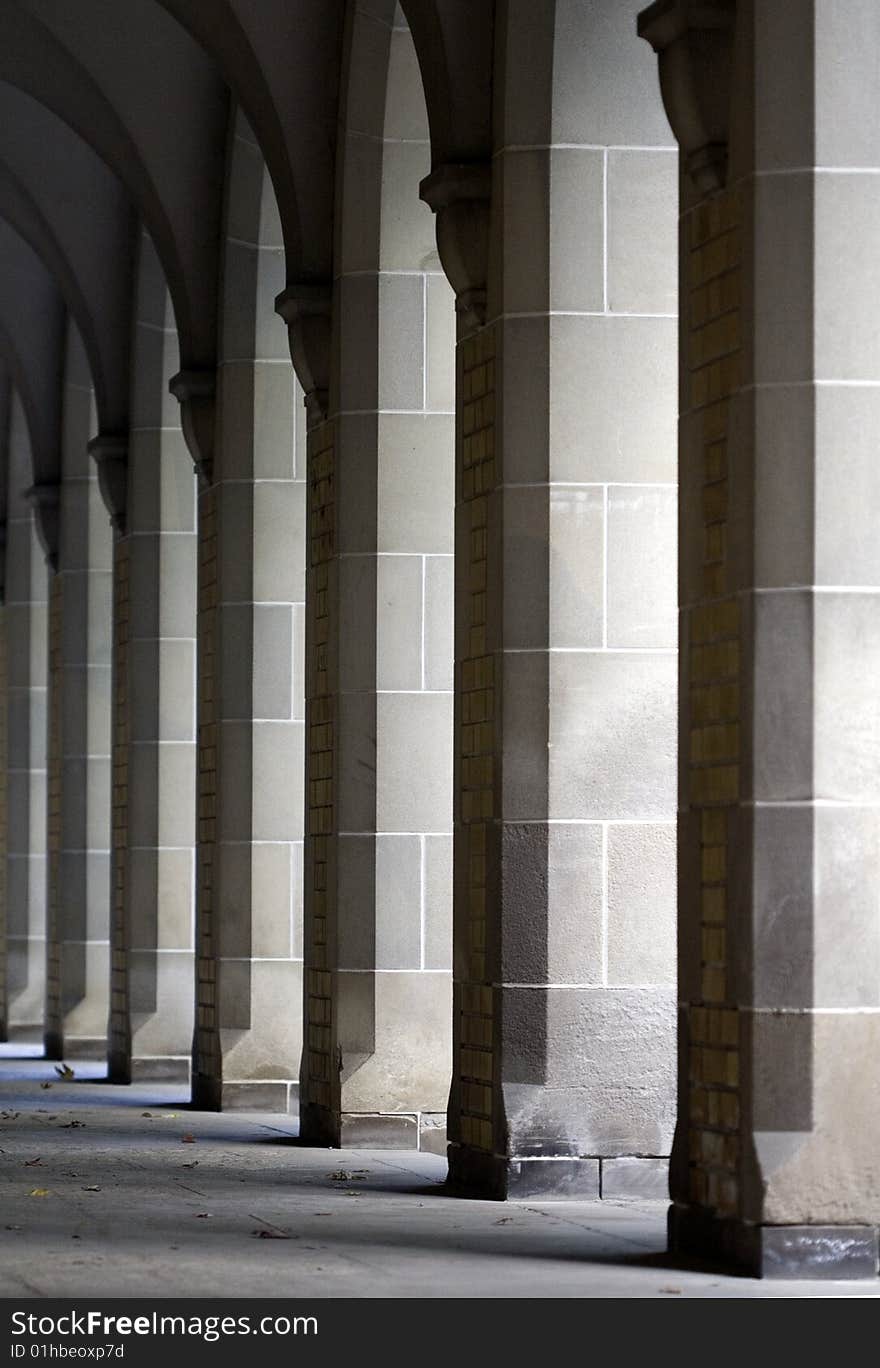 Row of Repeating Columns with Sunlight Shining Through