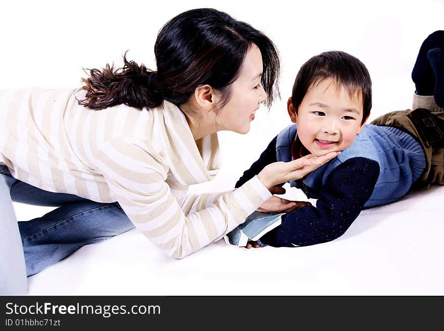 A picture of a little chinese boy playing games with his mother and having great fun. A picture of a little chinese boy playing games with his mother and having great fun