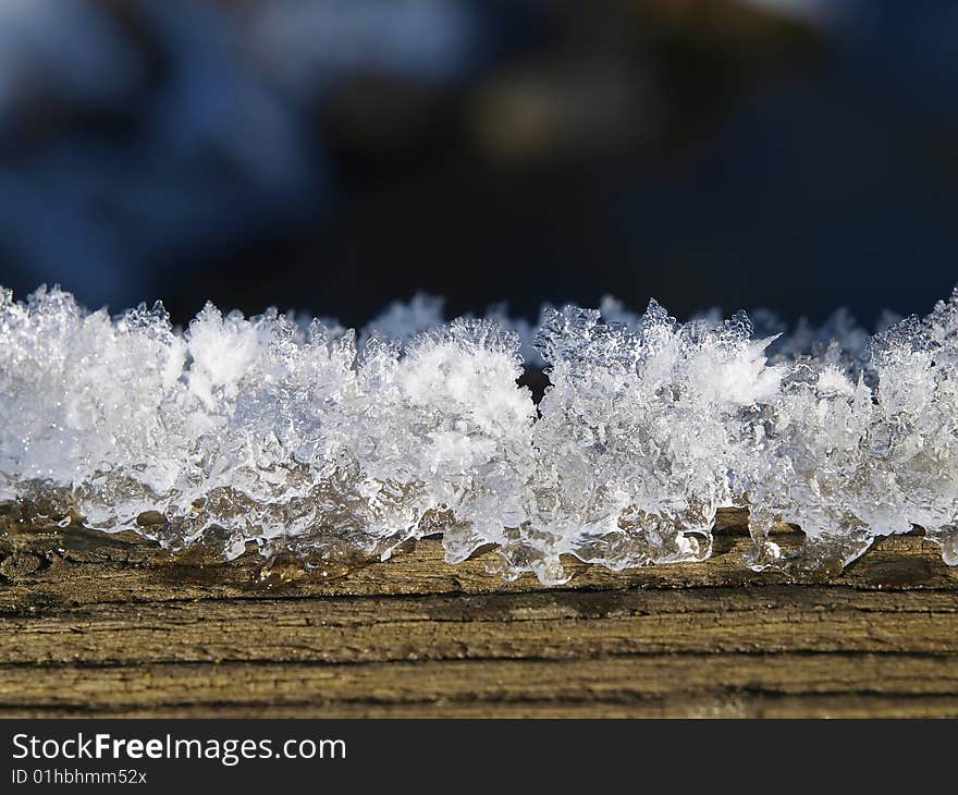 Melting snow at wooden plank