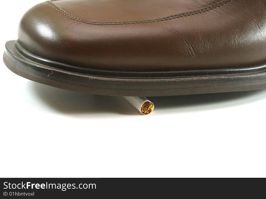 On a white background, shoes stepped on a cigarette