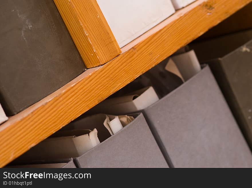 On the wooden shelving folders cost with different papers. On the wooden shelving folders cost with different papers.