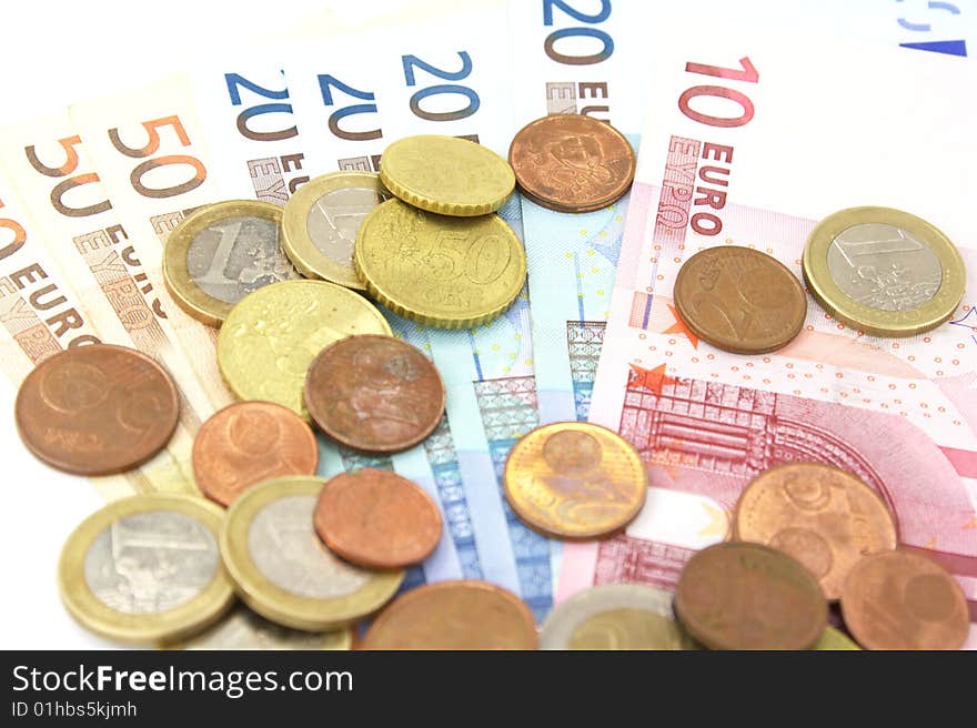 Euro coins and banknotes isolated over white. Euro coins and banknotes isolated over white