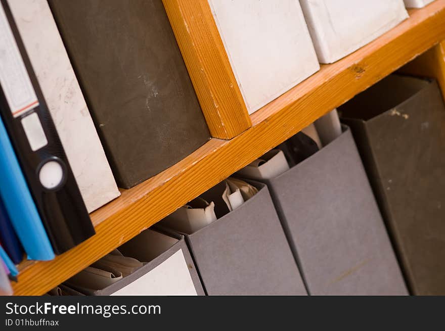 On the wooden shelving folders cost with different papers. On the wooden shelving folders cost with different papers.