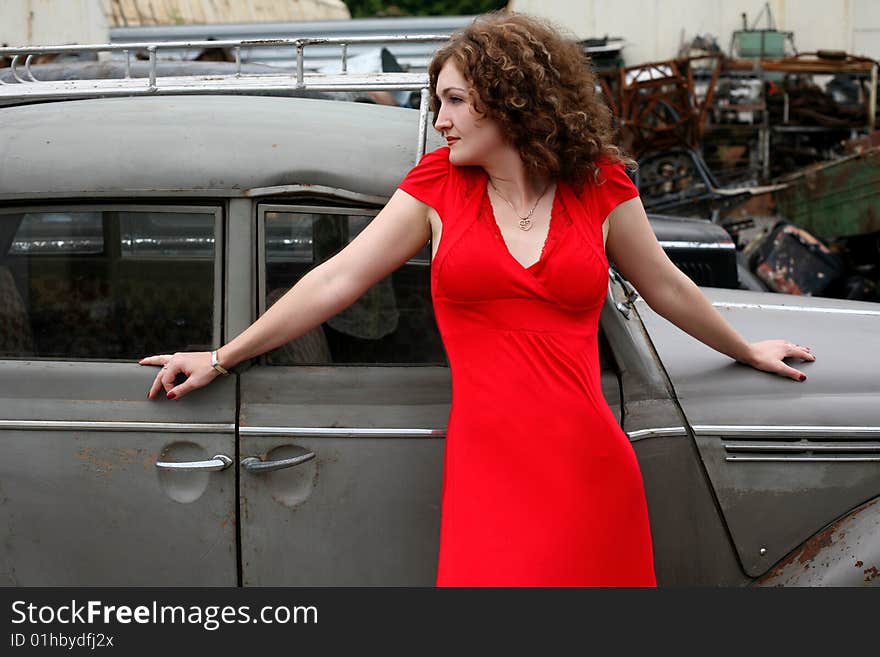 Brunette beside retro car