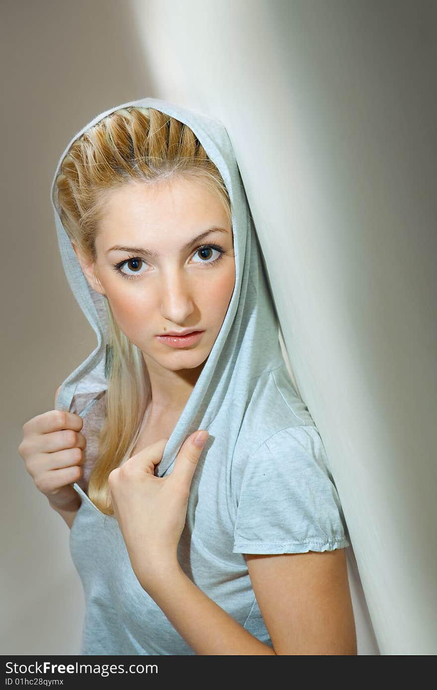 Portrait of young beautiful woman in a jacket with a hood