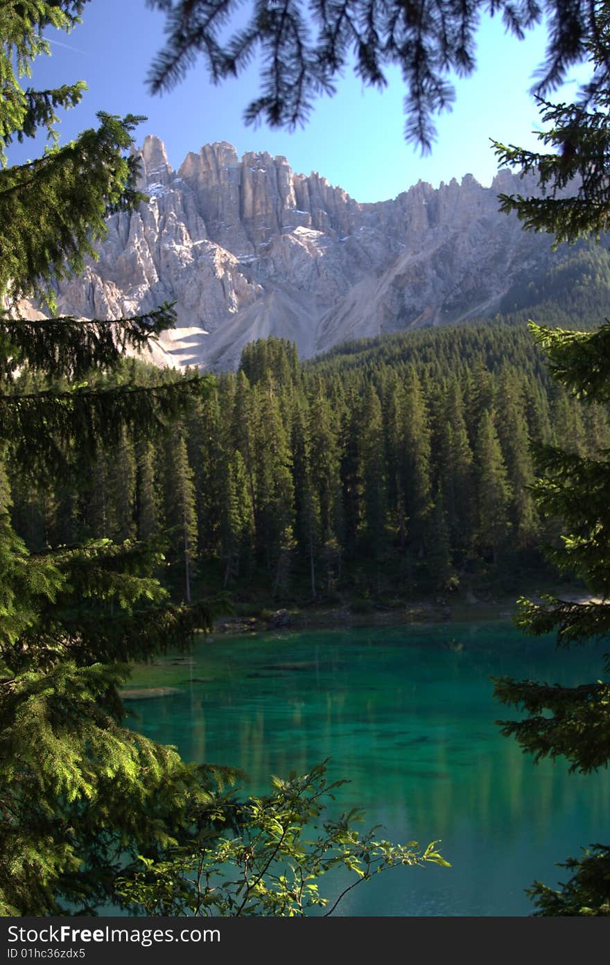 Mountain lake in the dolomites framed by trees. Mountain lake in the dolomites framed by trees