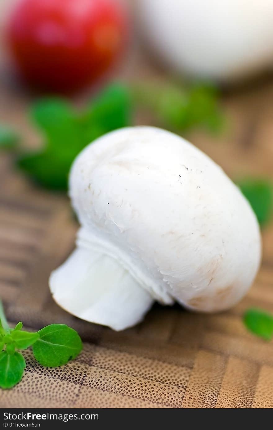 Fresh mushrooms isolated on a wooden background