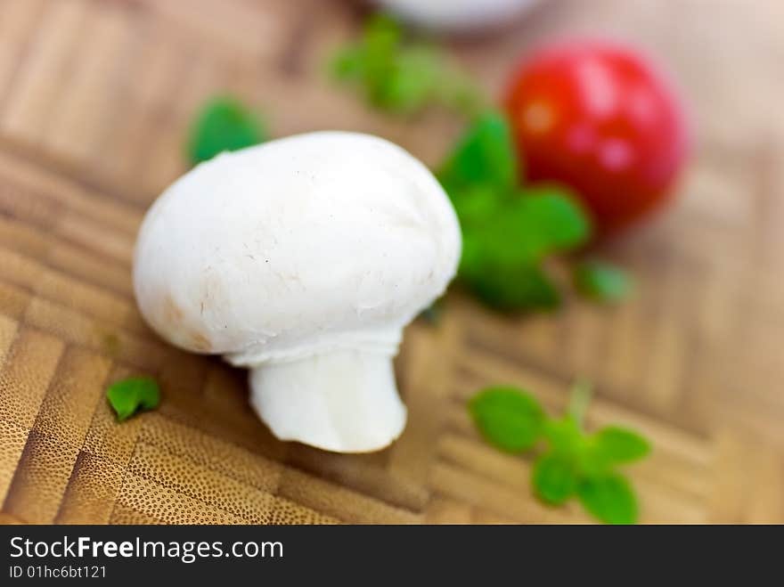 Fresh mushrooms isolated on a wooden background