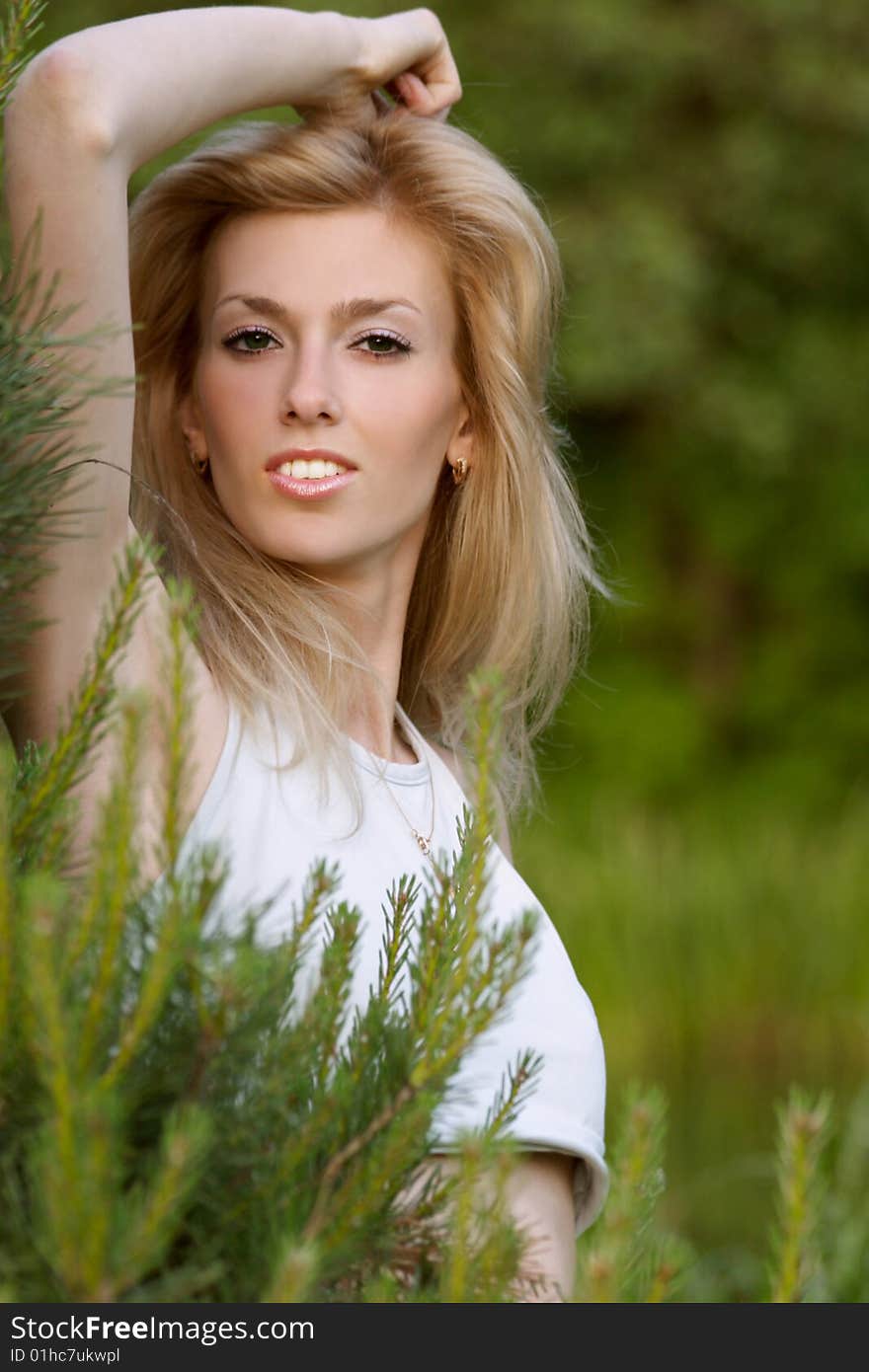 A portrait of a cute blonde in forest