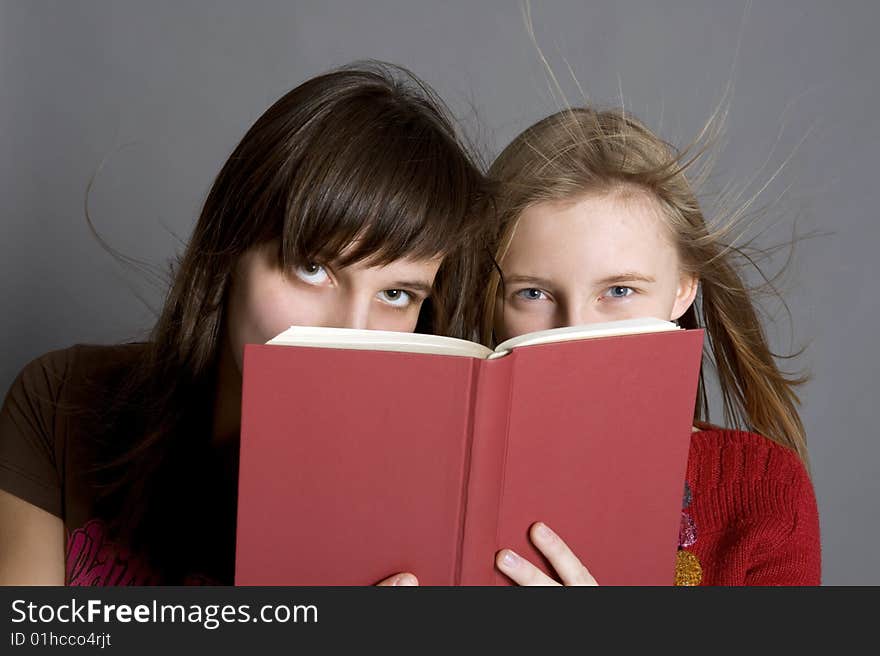 Two teenagers read the book. Two teenagers read the book