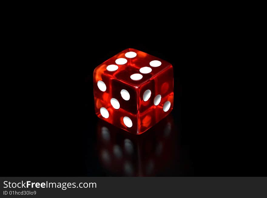 A dice on a black background.