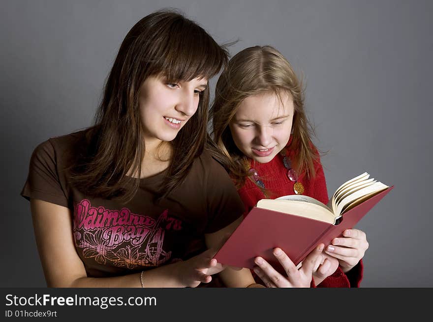 Two teenagers read the book. Two teenagers read the book