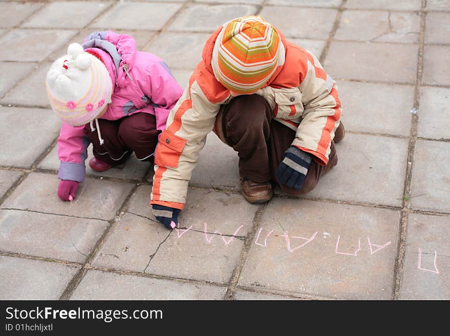 Two children with chalk on road