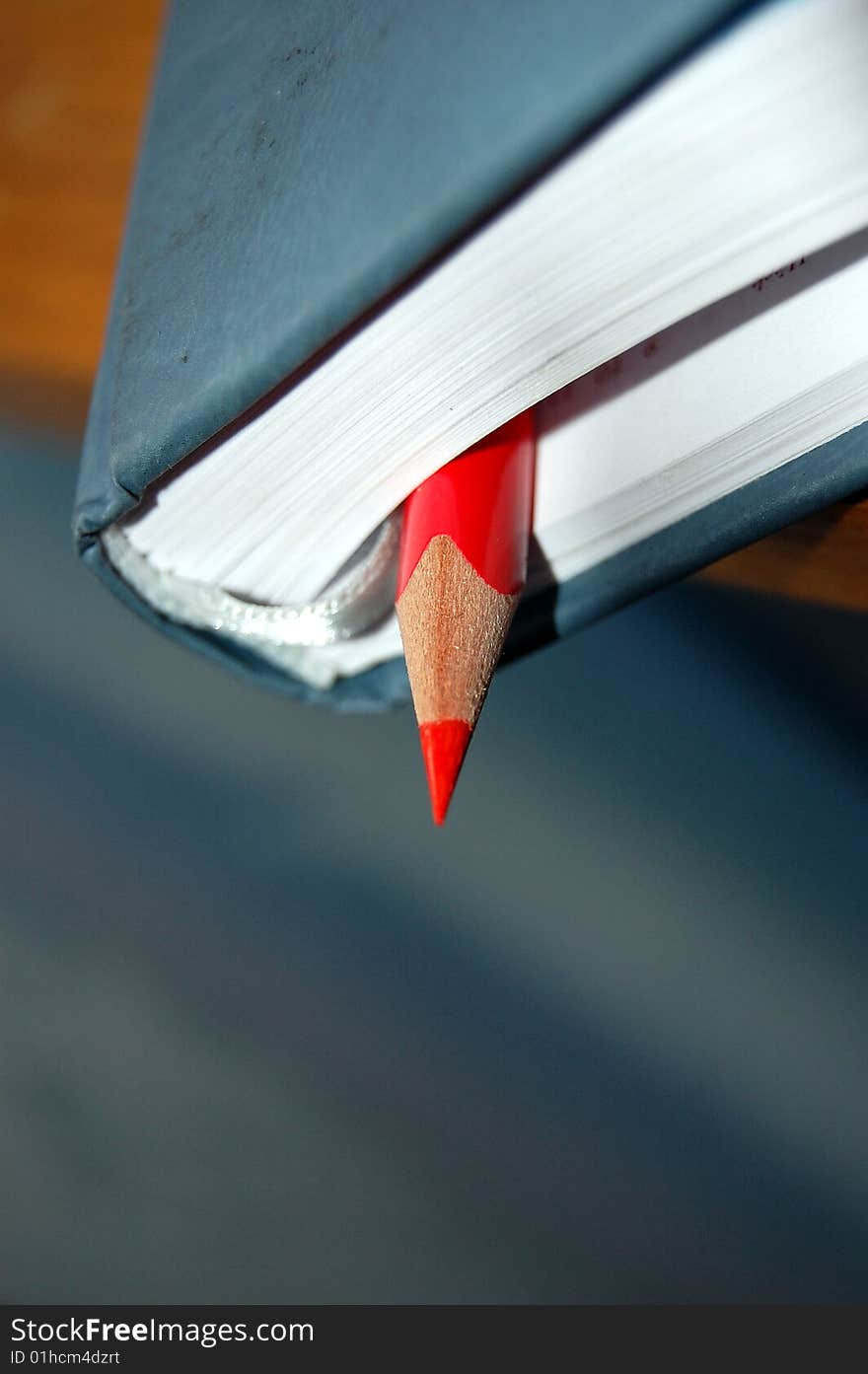 Red pencil and old notebook