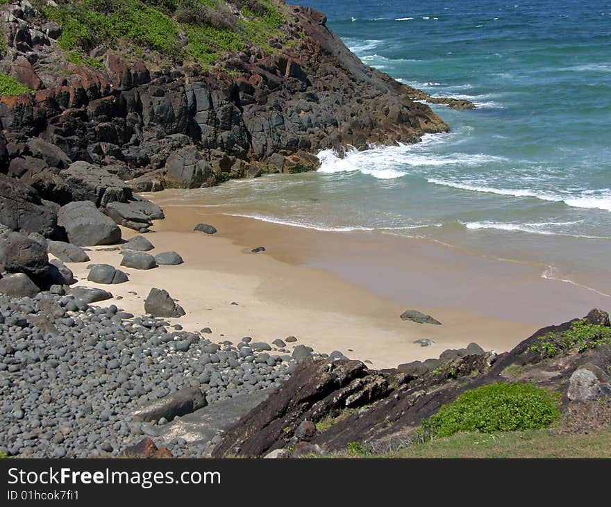 A small but secluded prisitne beach with a rocky outcropping on the northern NSW coastline of Australia. A small but secluded prisitne beach with a rocky outcropping on the northern NSW coastline of Australia.