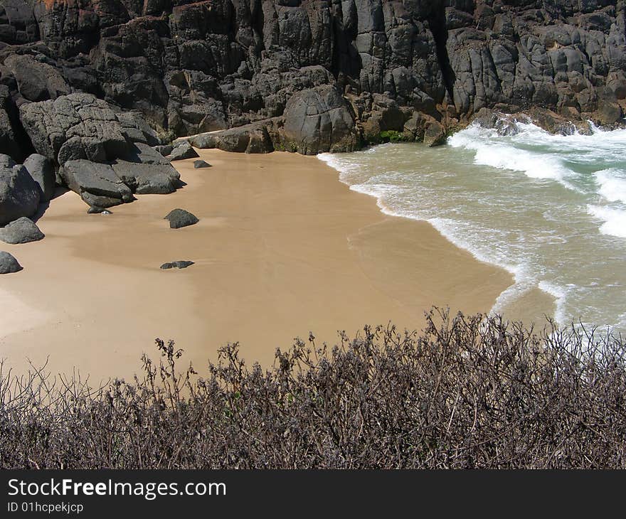 A small but secluded prisitne beach with a rocky outcropping on the northern NSW coastline of Australia. A small but secluded prisitne beach with a rocky outcropping on the northern NSW coastline of Australia.