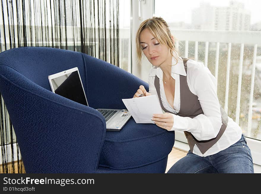 Woman studying at home on a rainy day. Woman studying at home on a rainy day