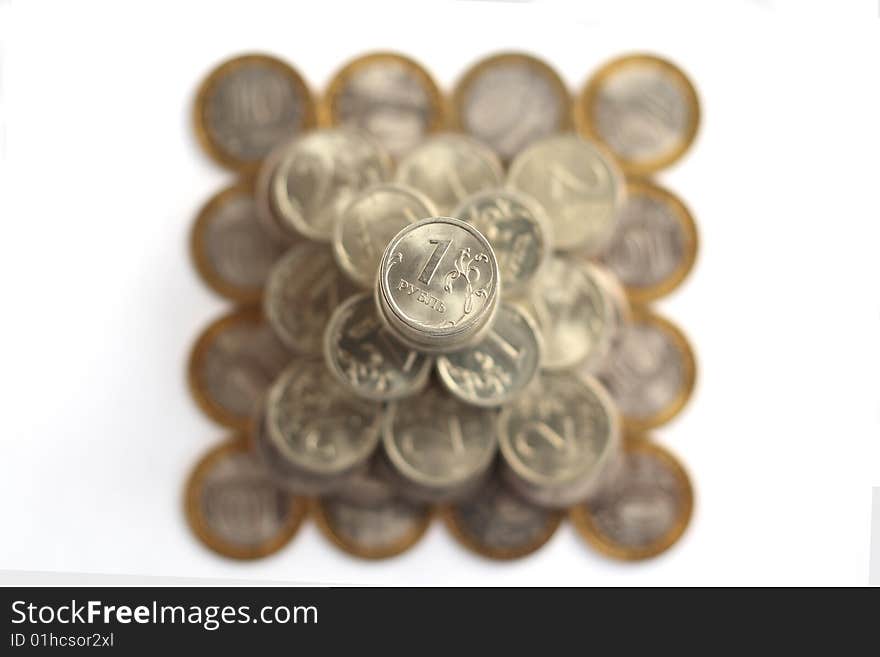 Pyramid of coins isolated on white background from above