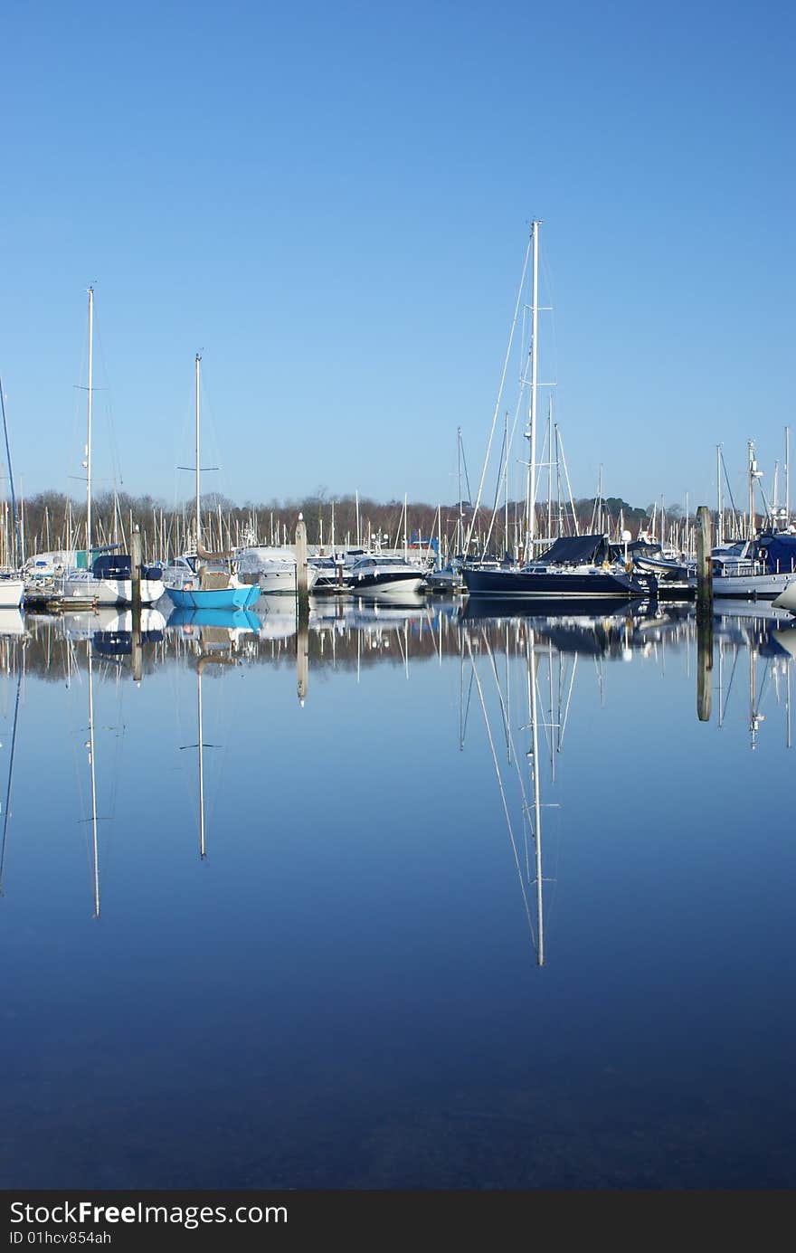 Image of yachts reflected in water. Image of yachts reflected in water