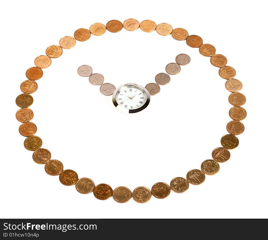 A clock made of coins on the white background with a watch in the centre. A clock made of coins on the white background with a watch in the centre