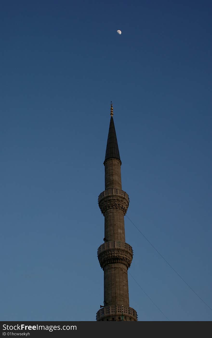 Muslim symbol of a minaret with moon on sky. Muslim symbol of a minaret with moon on sky