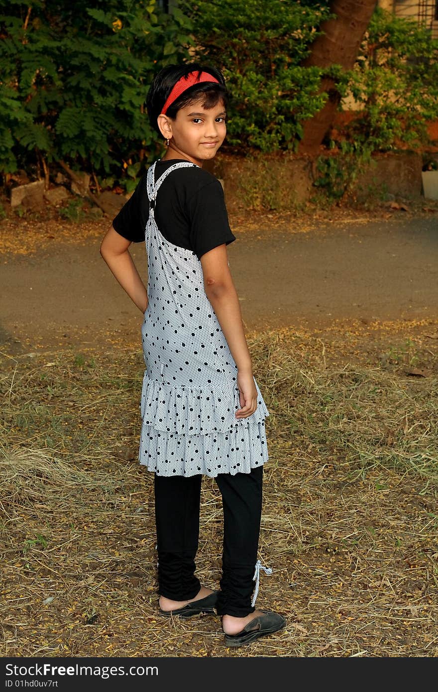 A rich Indian girl happily posing for the photo. A rich Indian girl happily posing for the photo.