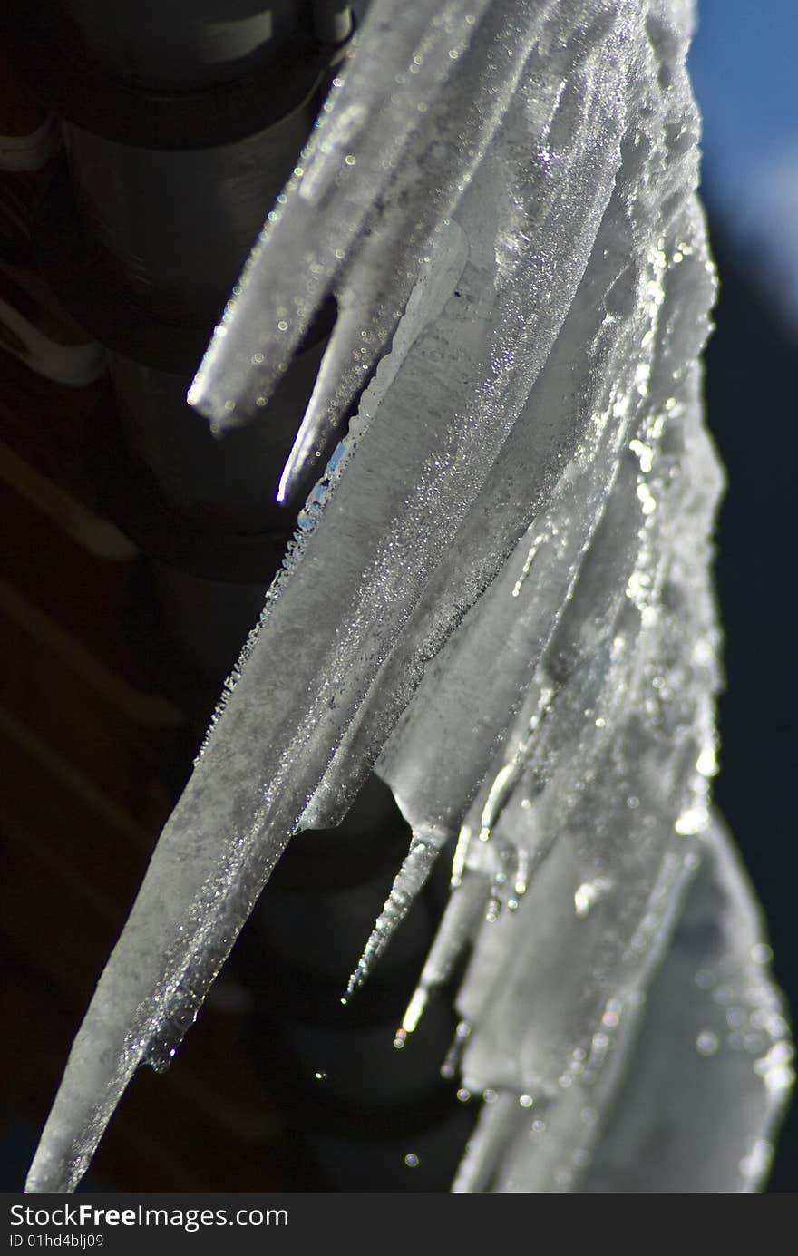 Swiss chalet roof with huge icicles formed over night after the thaw had reversed. Swiss chalet roof with huge icicles formed over night after the thaw had reversed