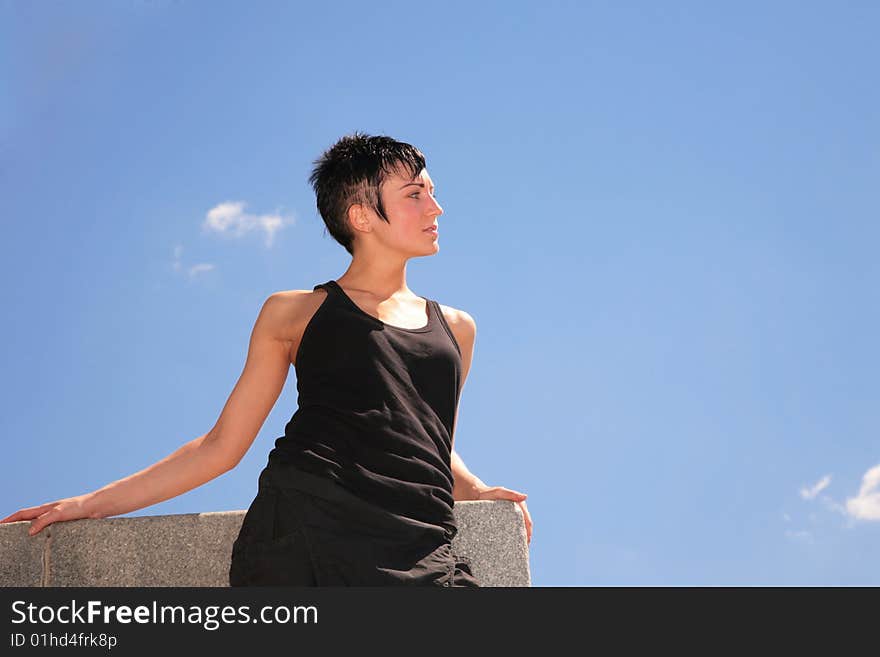 Beautiful brunette on blue sky