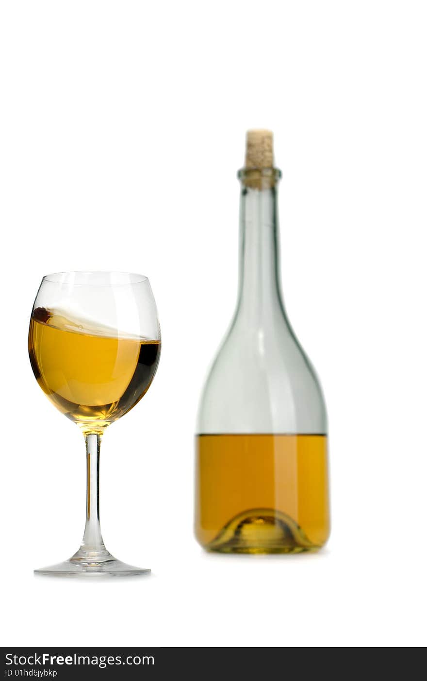 Glass and bottle of excellent white wine on a white background