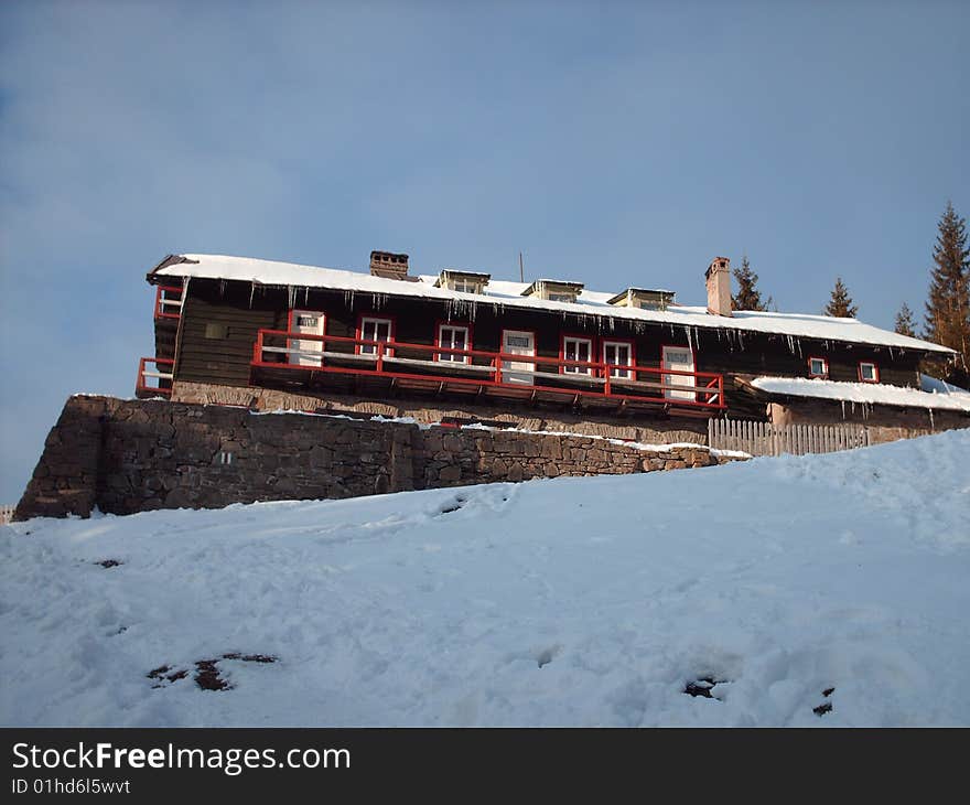 Cabana Fantanele surrounded by snow.