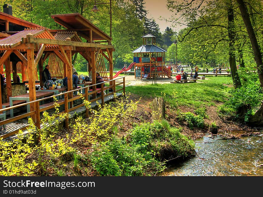 Wooden table and benches at creek and trees. Wooden table and benches at creek and trees