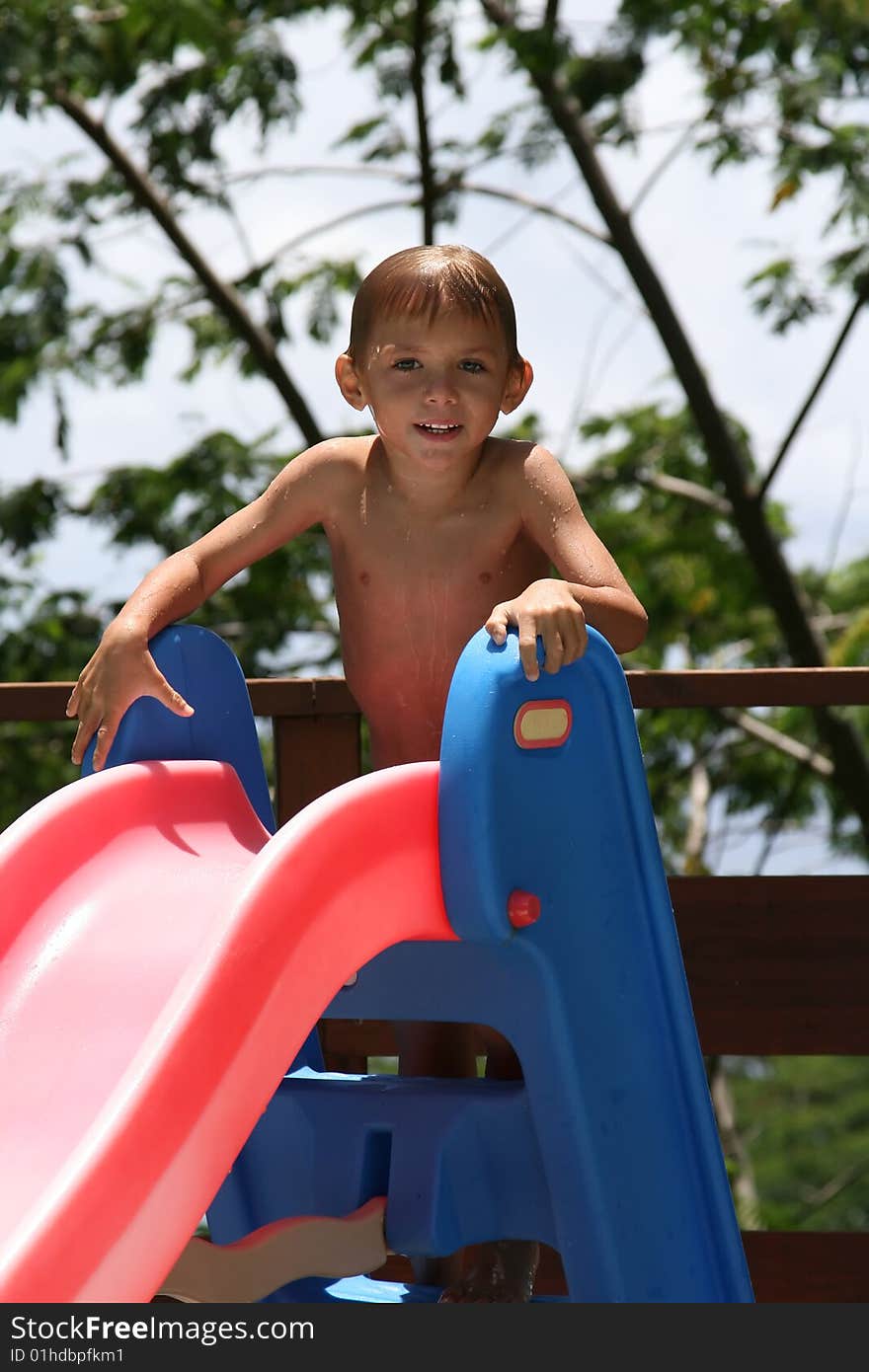 Boy on a water slide, in summer time