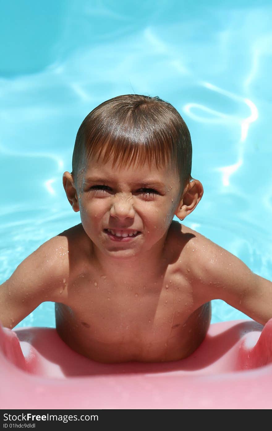 Boy frowning in a swimming pool