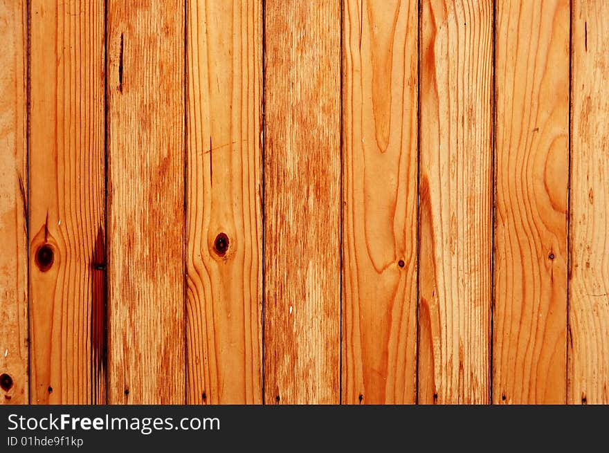 Wooden fence made of unfinished pine boards