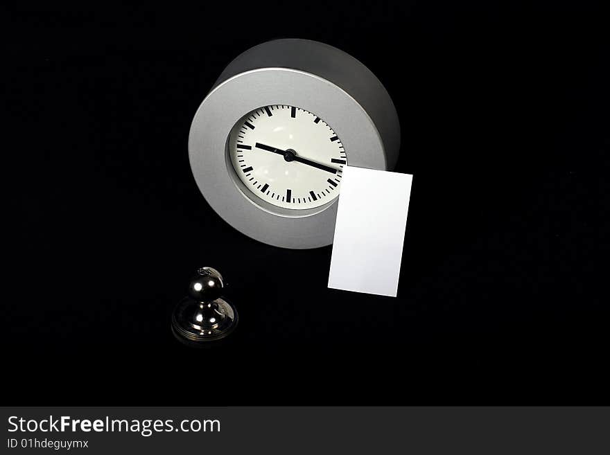 Card standing near modern clock and stamp. Card standing near modern clock and stamp