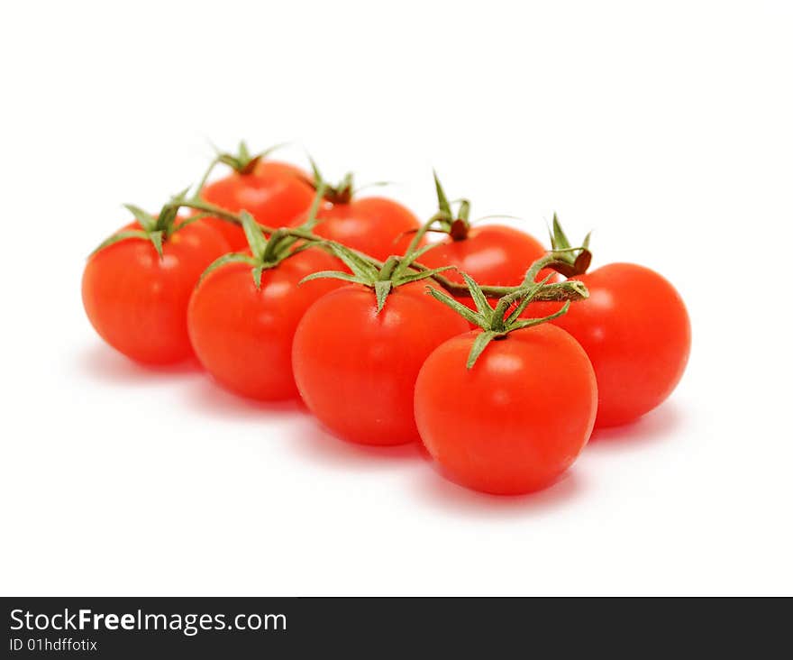 Eight cherry tomatoes on branch