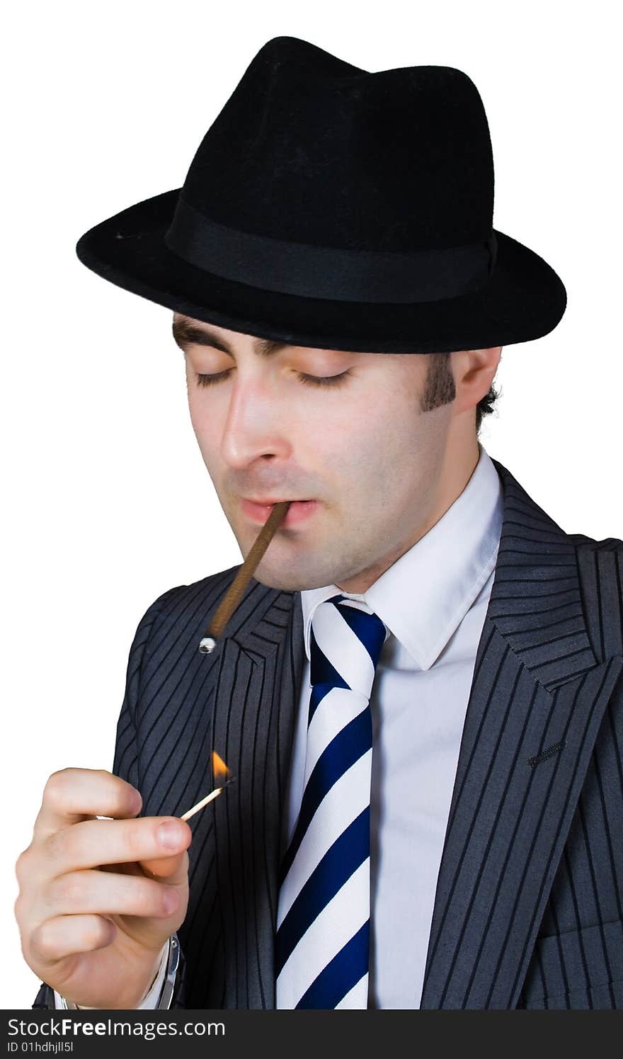 Retro businessman light a cigarette isolated over white with clipping path