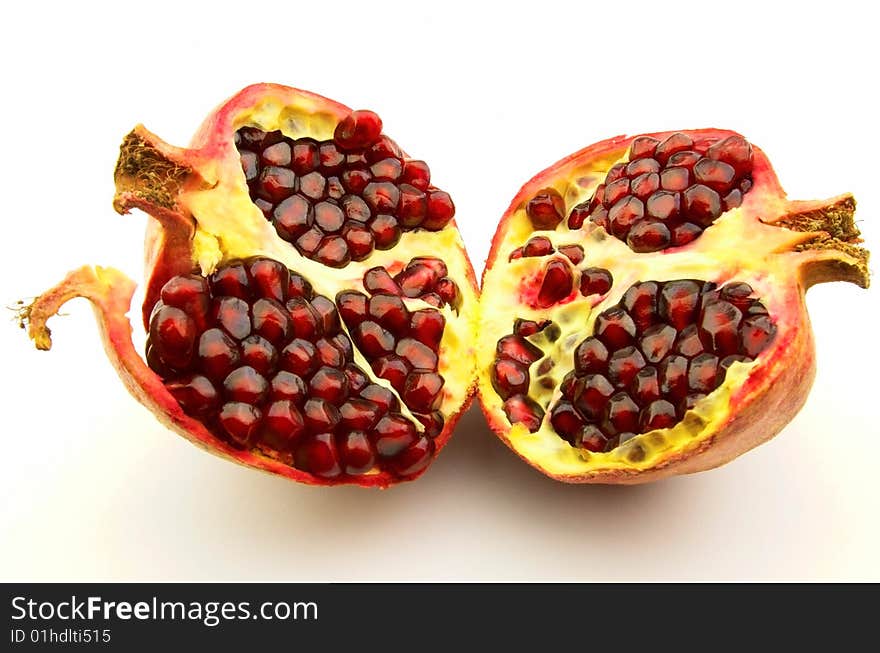 Cut pomegranate on a white background