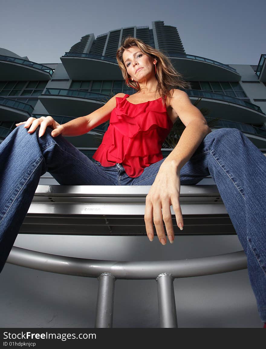 Beautiful woman sitting upon a bench. Beautiful woman sitting upon a bench