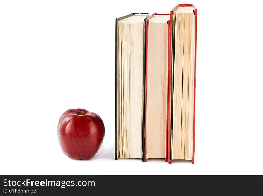 Red apple and books isolated on white. Red apple and books isolated on white